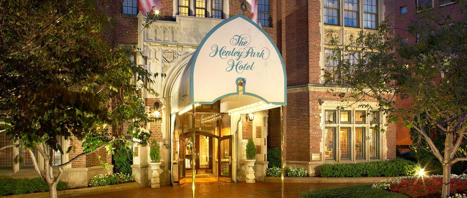 The entrance of a hotel with a lit awning