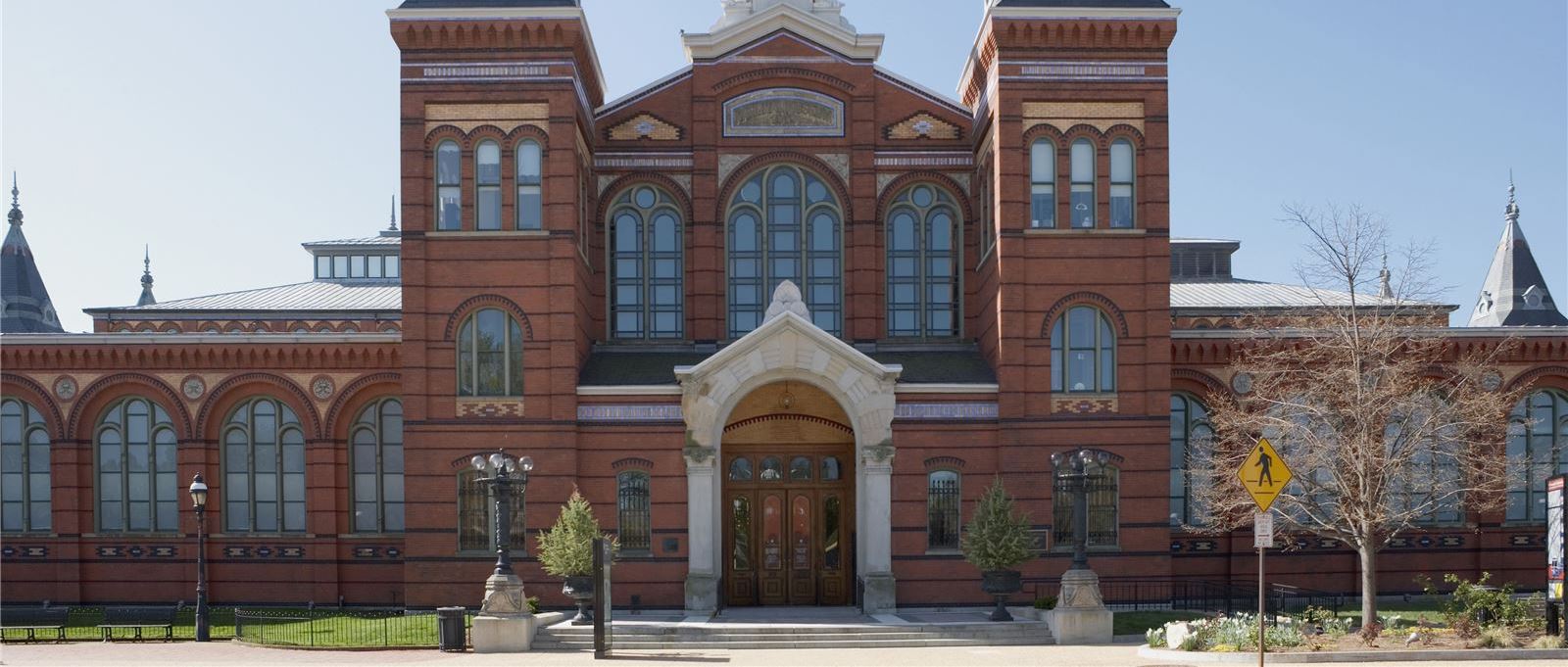 A large red brick building with arched windows and a grand entrance.