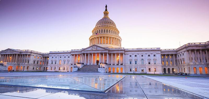 A wide-angle view of the United States Capitol Building at sunset